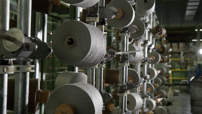 Spools of yarn on a warping creel