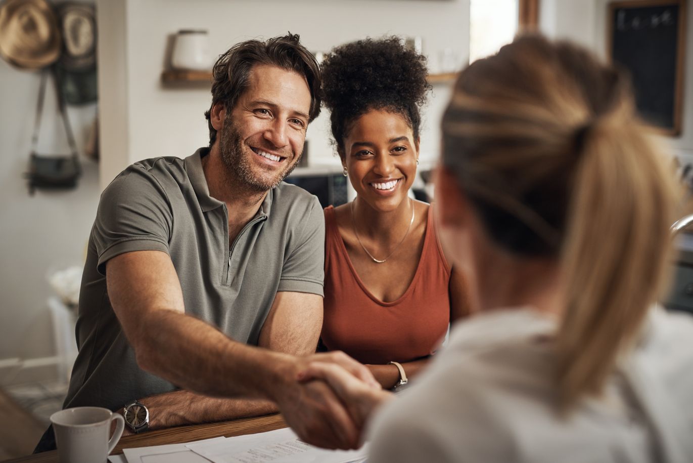 A happy couple talking to a sales representative